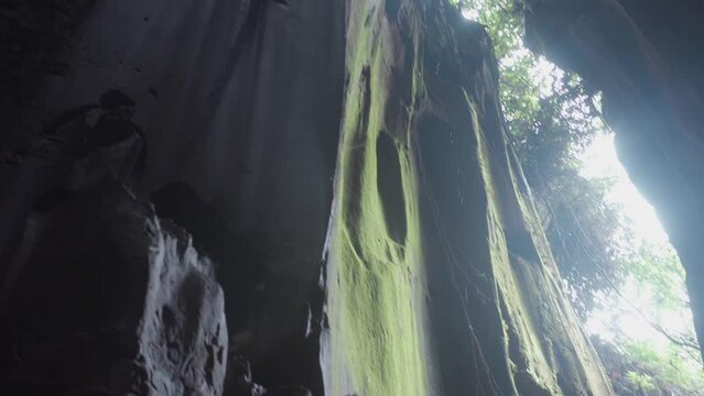 A shot taken from top to the foot pf a rocky cave valley