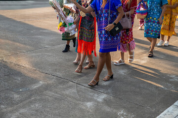 group of tribal women are walking to charity..