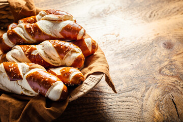 Pretzel sticks and pretzel rolls, Bavarian lye bun with salt in a basket - obrazy, fototapety, plakaty