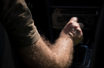 Closeup of arm driving in car