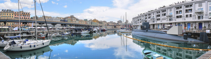 Panoramic view of Genoa marina, with submarine, boats, buildings and nice reflection - obrazy, fototapety, plakaty