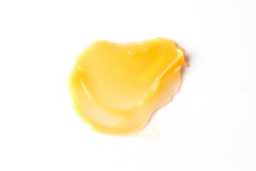 Yellow cremy swatch on white background. Butter cleanser smear. Cosmetic beauty product sample