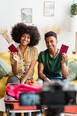 afro couple shows their passports for their video blog