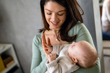 Family, motherhood, parenting, people baby and child care concept. Happy mother with adorable baby
