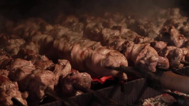 Pork on skewers grilled in a charcoal grill. Barbecue kebab meat for dinner