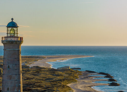 Beach coastline with the famous Skagen Grey Lighthouse, Skagen Gr&aring; Fyr, Skagen, Grenen in North Jutland in Denmark, Skagerrak, North Sea, Baltic Sea. Upper tower platform, lantern of  lighthouse.