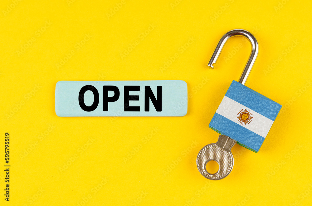Poster on the yellow surface is an open lock with a key and a sticker with the inscription - open