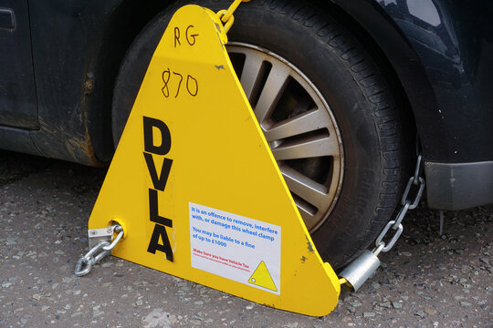 Southampton England - 22 March 2023 - A penalty wheel clamp on car wheel illegally parked.