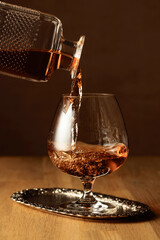 Brandy is poured into a snifter glass.