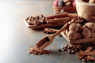 Chocolate truffles and spoon with cocoa powder.