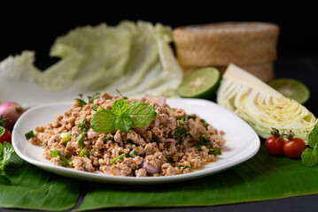 Local Thai food, Spicy minced pork salad (Larb Moo) eating with fresh vegetables 