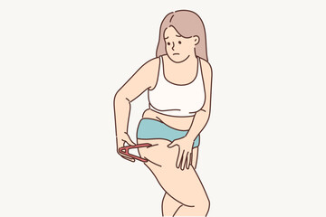 Woman measures percentage of fat on legs using calipers tracking result of diet for weight loss 