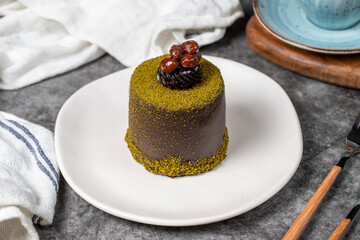 Chocolate cream cake. Cake with pistachio and chocolate cream on a dark background. patisserie desserts