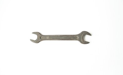 On a white isolated background, the wrench lies horizontally.  Concept design and hand tools, plumbing work.  Flat lay, top view, closeup,