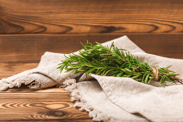 Branches of fresh rosemary on a brown texture background. Spicy spices. Seasoning for meat and fish. Cooking concept. RECEPT. Close-up. place for text.