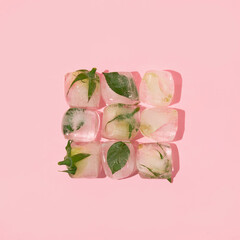 Spring creative layout with pink roses in ice cube on pastel pink background. 80s or 90s retro fashion aesthetic bloom concept. Minimal romantic Valentines day, Mothers day or women day idea.