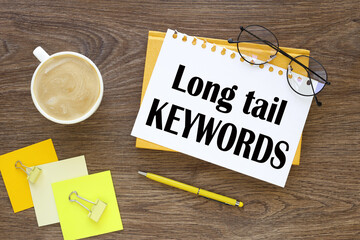 Business concept.Text Long Tail Keyword torn paper on a yellow notebook on a wooden background.