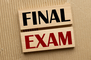 FINAL EXAM two wooden blocks with text on a craft background