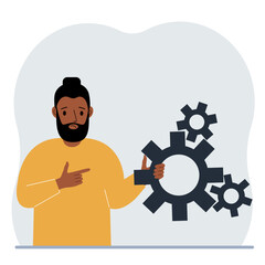 A man holds gears in his hand. Points a finger at the cogwheels. The concept of financial planning, movement, life, education or maintenance.