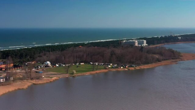 Aerial view looking over Lake Resko Przymorskie and Rogowo near Kołobrzeg in Poland with the Baltic Sea in the background