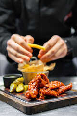 chef cookind chicken breast strips and french fries on restaurant kitchen