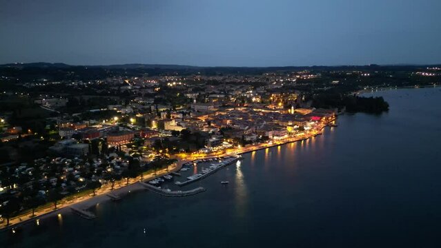 Aerial View Of Lazise Comune At Night With Marina On Lago di Garda In Italy.