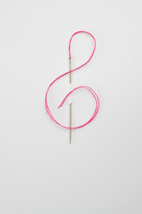 Red cord through the Needle In The Form Of A Treble Clef - 595834760