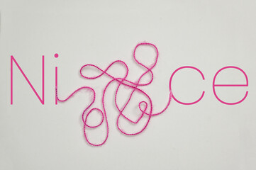 Nice word Written With Letters and Tangled Thread