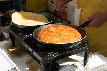 Cooking of Frico typical Friulian dish based on potatoes and cheese,italy
