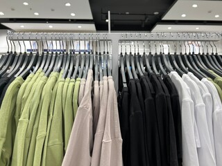 Clothes on hangers in the store. Large assortment of shopping fashion. An image of a wardrobe.