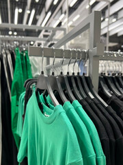 Clothes on hangers in the store. Large assortment of shopping fashion. An image of a wardrobe.