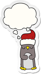 cartoon christmas penguin with thought bubble as a printed sticker