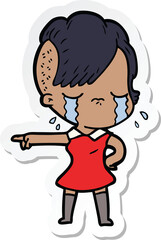 sticker of a cartoon crying girl pointing