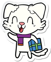 sticker of a laughing cartoon dog with christmas present