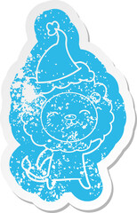quirky cartoon distressed sticker of a lion wearing santa hat