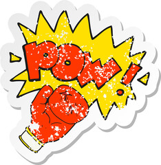 retro distressed sticker of a cartoon boxing glove punching
