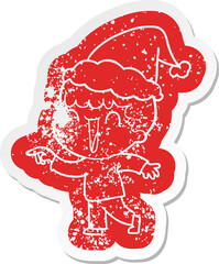 laughing quirky cartoon distressed sticker of a man pointing wearing santa hat