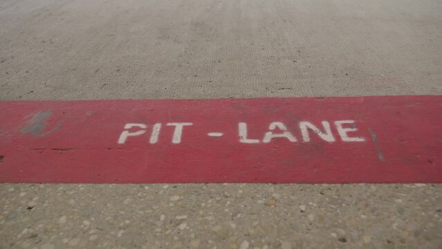The inscription pitlane on the asphalt of the Formula 1 race track. High quality 4k footage. Slow motion