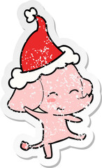 cute hand drawn distressed sticker cartoon of a elephant dancing wearing santa hat