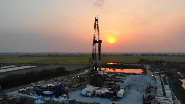 Sunset oil drilling rig in the field