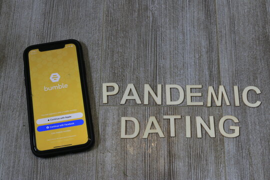 London Canada, May 04 2021: Editorial illustrative photo of the bumble app next to pandemic dating. Theme of tough dating