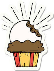 sticker of a tattoo style cupcake with missing bite
