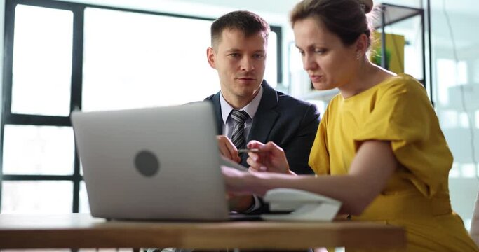 Partners at working laptop discuss business processes and financial report. Business strategy development and collaboration