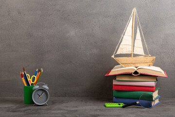 Education is a journey concept, toy boat and books on the table, inspiration for a writing a fairy...