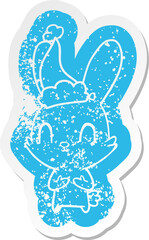 cute quirky cartoon distressed sticker of a rabbit wearing santa hat