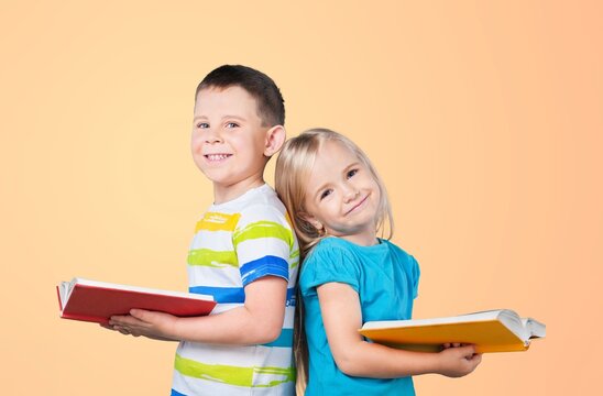 Happy young student holding books standing together