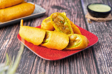 Mirchi bada is a spicy Indian snack consisting of chili and potato or cauliflower stuffing battered and fried, served hot with tomato sauce or occasionally with mint and tamarind chutney