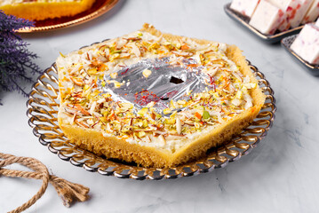 Ghevar or Ghewar is a Rajasthani cuisine disc-shaped sweet made from ghee, flour, and sugar syrup. It is traditionally associated with the month of Shravan and the Teej and Raksha Bandhan festivals