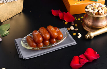 Gulab jamun is a sweet confectionery or dessert, originating in the Indian subcontinent and a type...