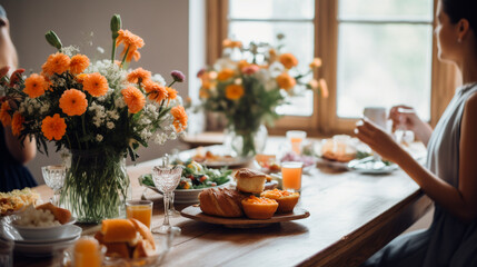 Brunch table with flowers and woman in the background soft focus. Generative AI,